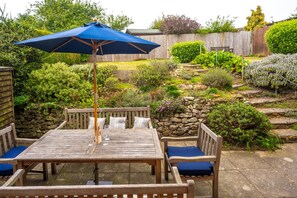 Sea Holly, Brancaster Staithe: Patio area with raised garden and flower borders