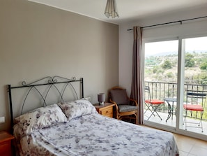 Double bedroom, ample storage and balcony with table and chairs