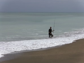 Fisherman on the private Ocean Village beach - 3000 ft of beachfront