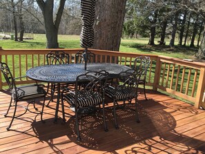 Large deck with many chairs with overview the property