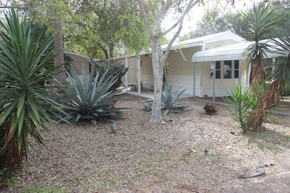 Front of lot with patio and carport