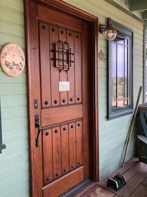 The front door has a 'speakeasy' grille and viewing door that opens from inside.