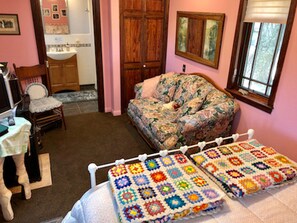 Another view of the sitting room. Several windows allow the natural light in. 