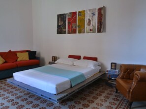 Large bedroom with queen bed and sofa