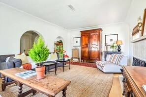 Spacious Living room with wood burning fireplace and TV armoire in Main house