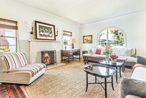 Living room windows flanking the wood burning fire place in main house