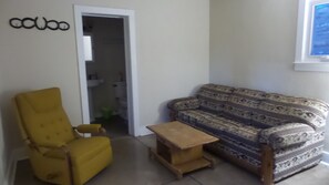 Sitting room with convertible couch - bath entrance.