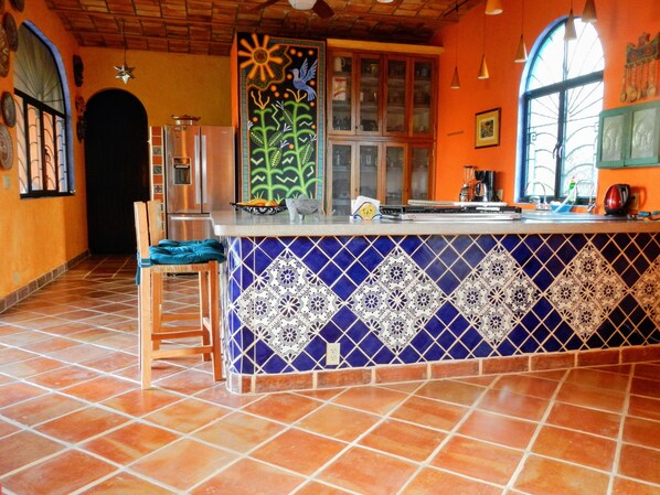 handpainted mural is centerpiece of kitchen