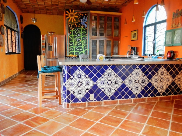 handpainted mural is centerpiece of kitchen