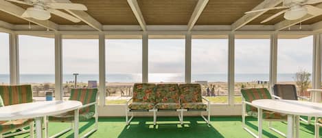 Covered front porch view of boardwalk, beach and ocean