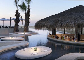 Ocean view infinity pool with in pool bar and dining area. 