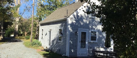 cottage with brick patio and outdoor shower