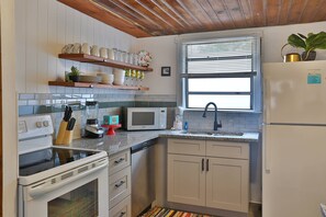 Updated Kitchen with Granite Counter Tops, Open Shelving, and a Starter Kit is Provided.