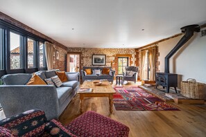 Oyster Barn, Titchwell: Sitting room with wood burning stove