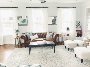 Living room featuring lots of natural light& plenty of seating