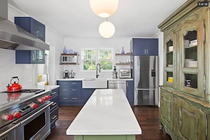 Chief's kitchen with elite appliances incl 48" Wolf range, grill, and griddle