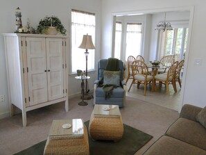 Great Room with TV cabinet, recliner.  Open to dining room.