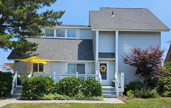 Single-family home with yard and 3-tiered wrap-around deck on the water
