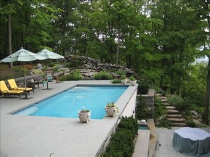 Pool, patio seating and "Lion Patio" with fountain on lower level.