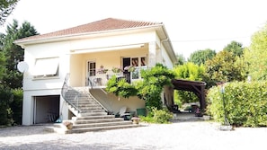 The front of the villa with extensive gardens and parking.