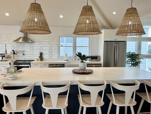 Long kitchen island for hosting, cooking and lunching. 