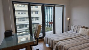 Bedroom with balcony and workspace