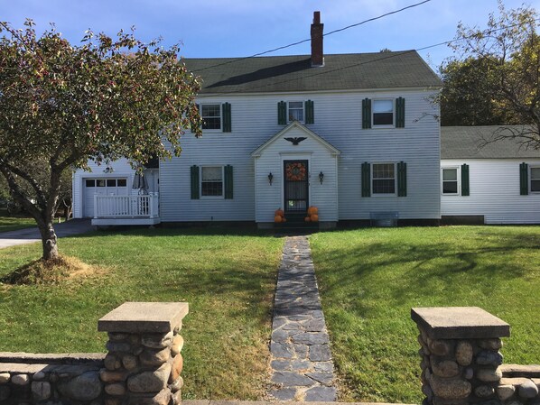 Front of House with stone wall entrance