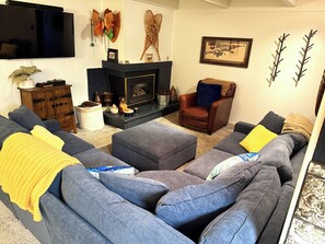 Comfy Living room with gas fire place and plenty of seating.