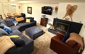 Comfy Living room with gas fire place and plenty of seating.