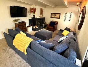 Comfy Living room with gas fire place and plenty of seating.