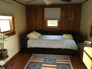 Bedroom has a daybed with trundle. This room also has a tv.