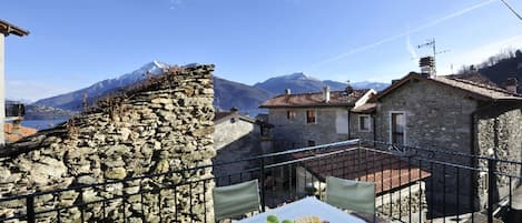 Al fresco dining on large balcony with views of lake and mountains