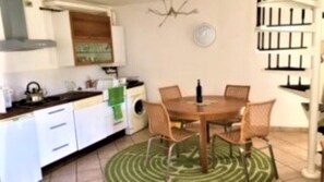 Dining area with extending dining table. First floor reached by spiral stairs.