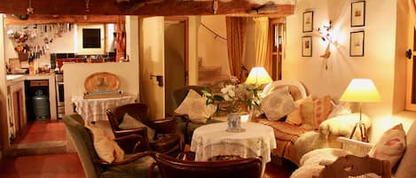 Living room with original 17th century staircase, dining room & kitchen