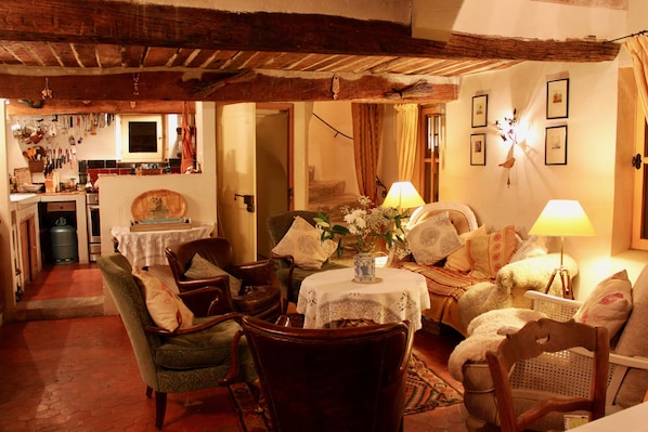 Living room with original 17th century staircase, dining room & kitchen