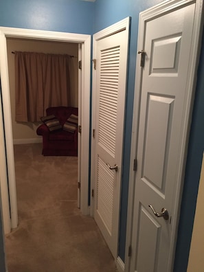 Hallway with stackable washer/dryer and closet pantry.