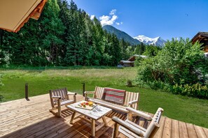 Sunny deck opening onto garden and then open ground