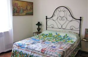 Double bedroom with antique furniture and paintings