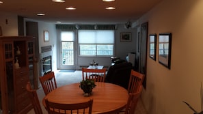 Dining set and view of great room with river view behind.