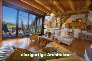 Living room with a magnificent view over green meadows and fields