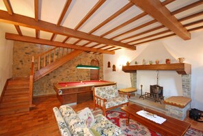 Living room with 3 sofas, pool table and dining area