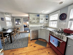 View from entry way of the Kitchen and Dining areas through to the Living Room.