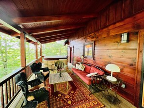 Covered deck off main floor living/dining area. Has a second door just at the hot tub.