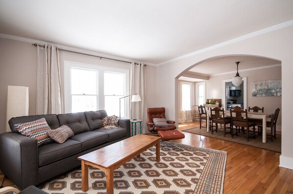 Main floor: Living room and dining room with hardwood floors throughout and plen