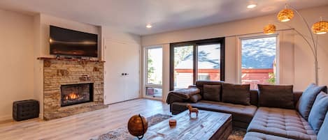 Lower living room with smart TV, gas fireplace and mountain views