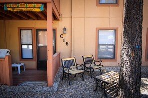 Entry into condo (ground level) with gas grill and seating areas outside