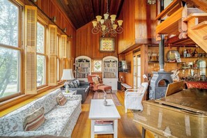 North-facing wall of living room with two couches, stereo system, bookshelves
