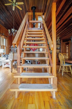 Solid mahogany staircase from living room to upper bedroom and workspace.
