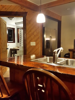 Kitchen bar with the main floor bathroom in the background.