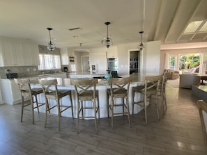 The open layout of the kitchen flows straight into the living and dining areas.